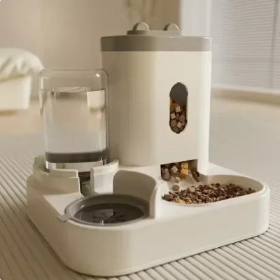 Pet feeding and water station with food and water containers on a wooden floor.