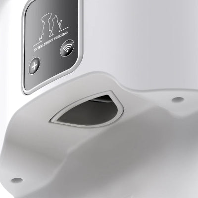 Close-up of a white electronic device with a control panel labeled 'Intelligent Feeding'.