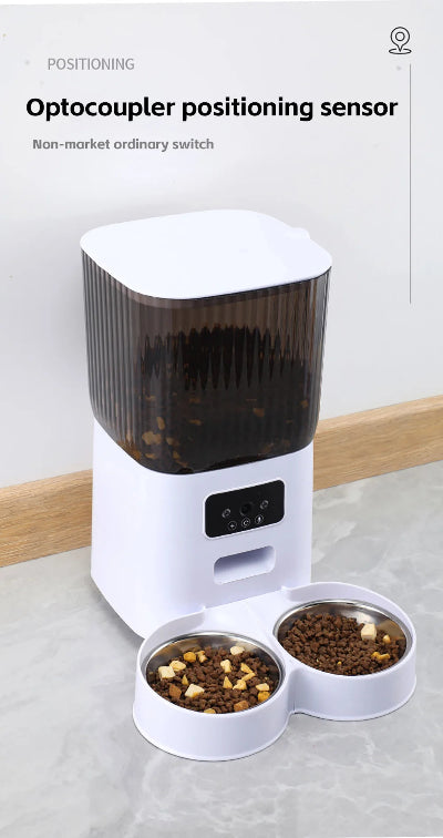 Pet feeder with two bowls of food on a light surface, featuring an optocoupler positioning sensor.