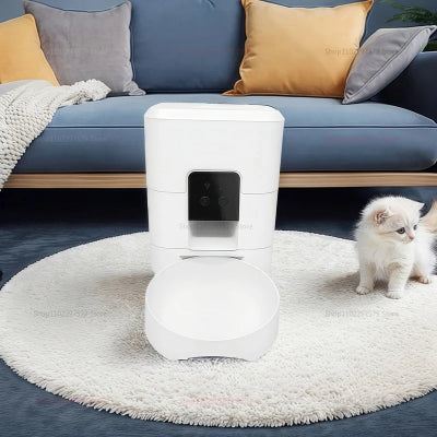 Pet feeder with 2.4G WiFi connection feature, cat sitting next to it on a wooden floor.