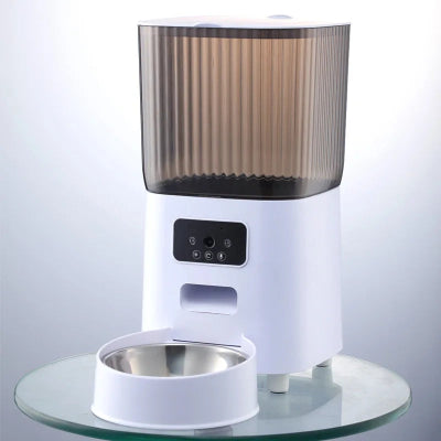 White pet feeder with a transparent brown top on a clear glass surface.