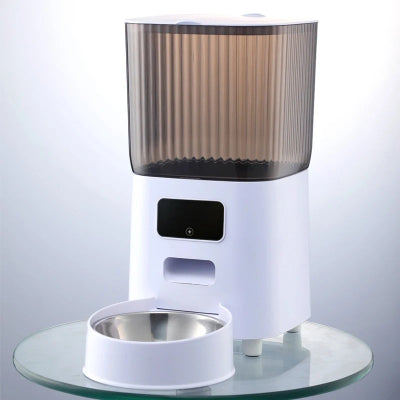 White pet feeder with a transparent brown top on a clear glass surface.